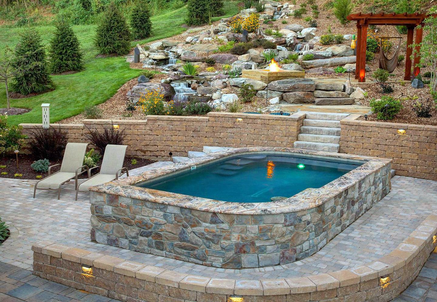 Custom Pool with Large Pondless Waterfall patio and fire pit